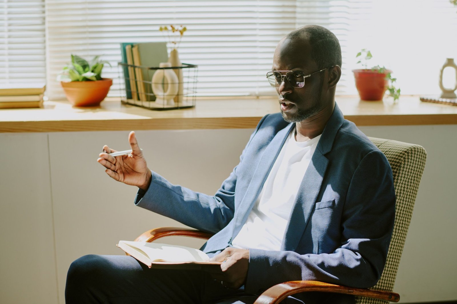 african-american-man-sitting-on-chair-holding-book-2025-02-11-05-36-16-utc (1) (1) (1)